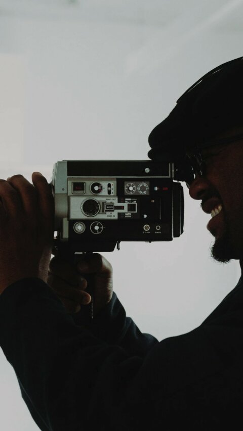Camera operator filming on set – Bloom production crew
