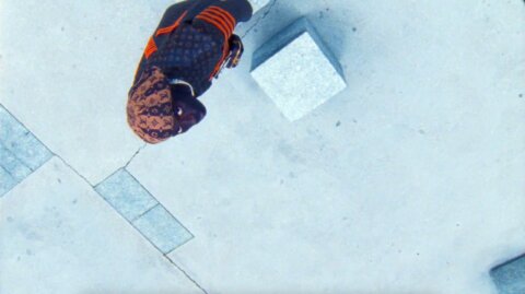 Top-down shot of a model on a white paved square – Louis Vuitton film, Paris