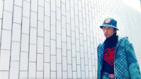 Model against a white tiled wall in La Dalle – Louis Vuitton, Paris