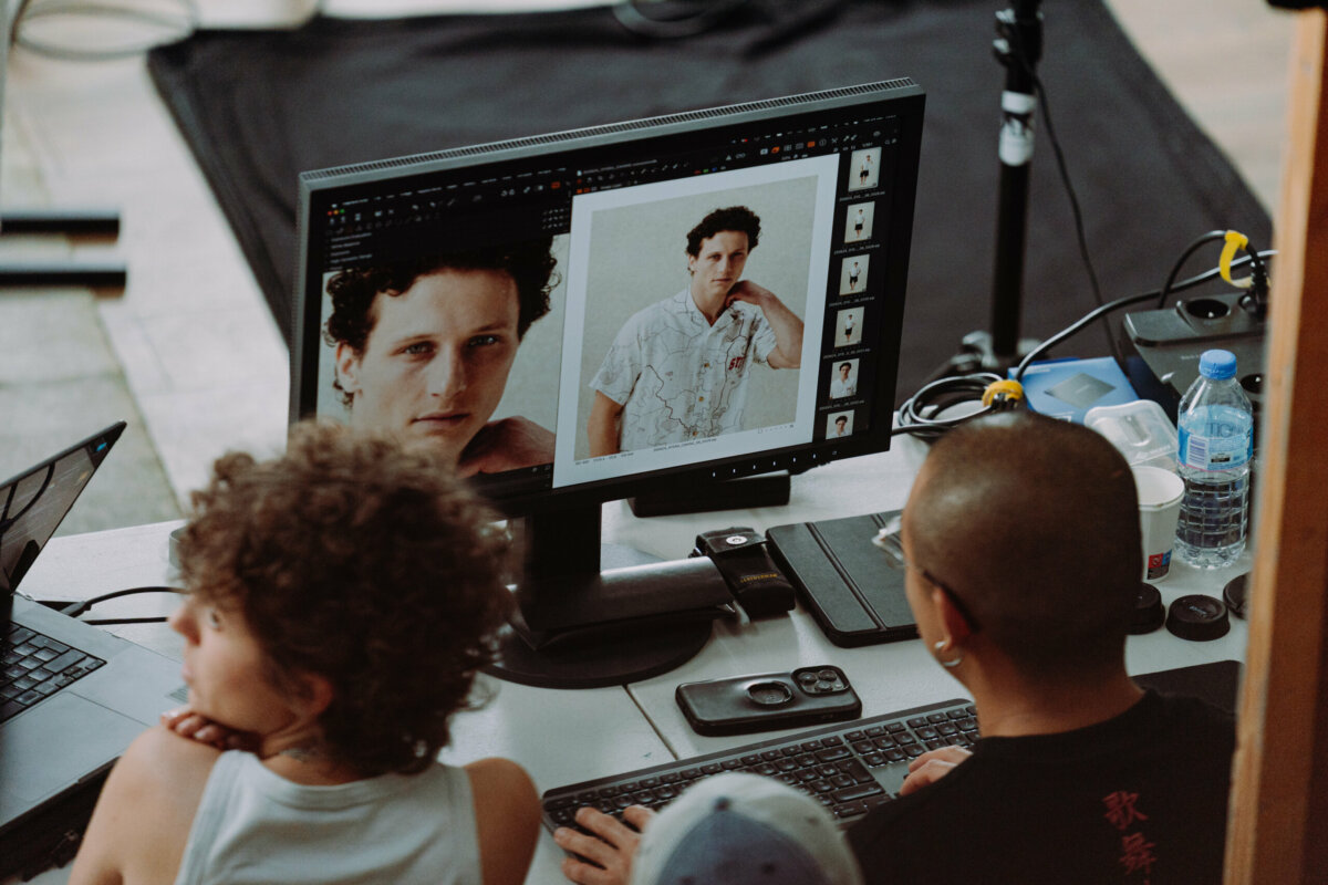 Art buying on set in Paris: photographer and digital tech reviewing a fashion portrait on the monitor