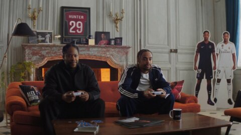 Friends gaming under a framed number 29 shirt in a manor salon – EA SPORTS FC 27