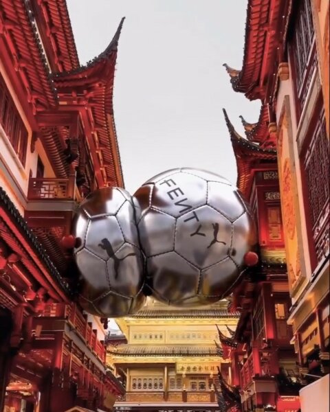 Giant chrome spheres floating between red pagoda-style gates – Fenty x Puma digital campaign